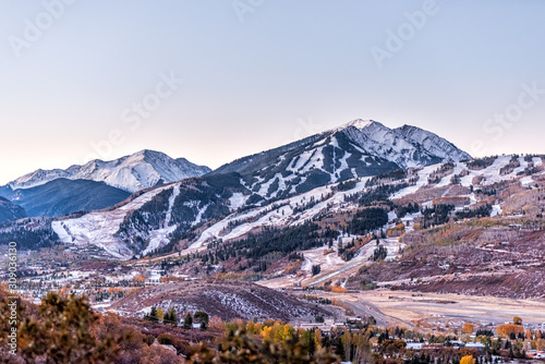 Aspen, Colorado rocky mountains high angle view of snow covered highlands and small airport runway in roaring fork valley in autumn