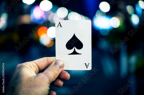 Ace Of Spades Playing Card In Cool Urban Setting Held By Hand Up Close Street Magic Concept