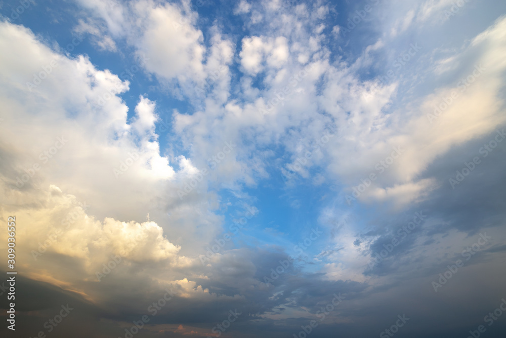 Blue sky covered with white puffy clouds.