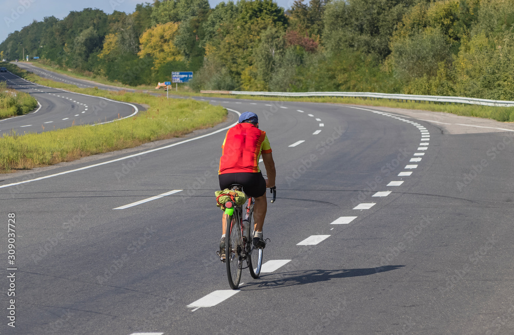 Cyclist rides on the highway on a bicycle