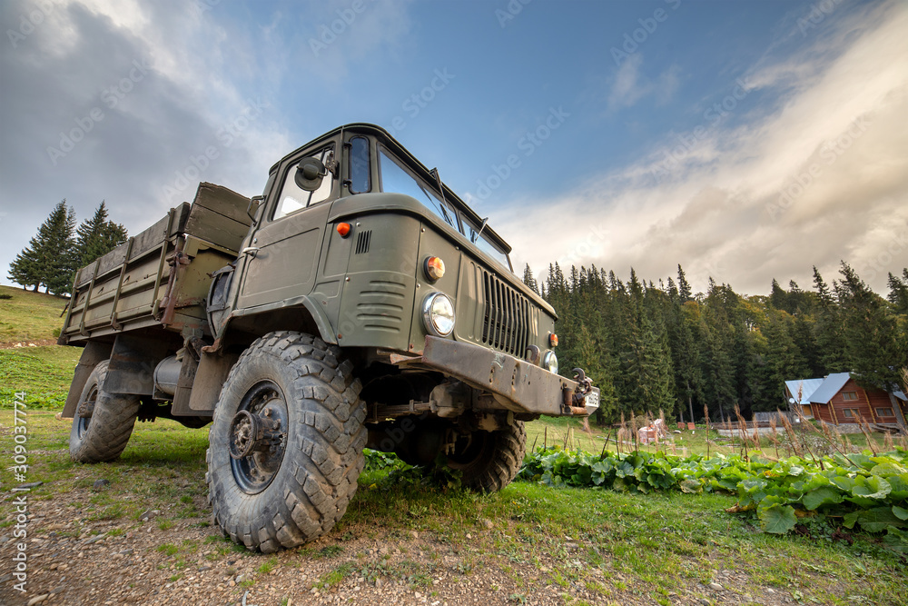 Obraz premium Old all terrain truck with big protector rubber tires for off road use.