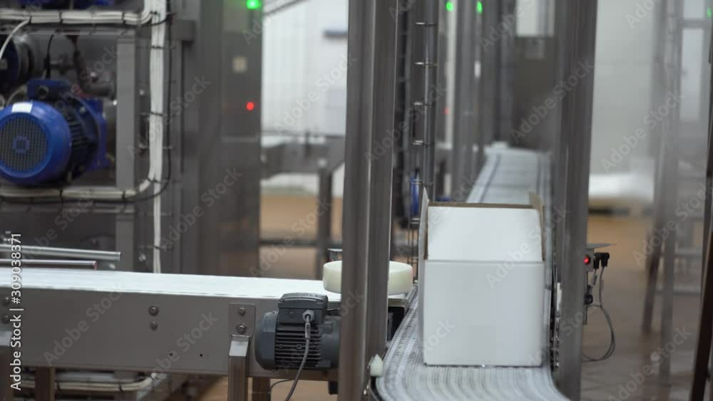 Movement of conveyor belt with one white cardboard box on it Movement of conveyor belt with one white cardboard box on it