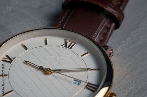 Close up macro watch on grey wooden board (ID: 309038305)