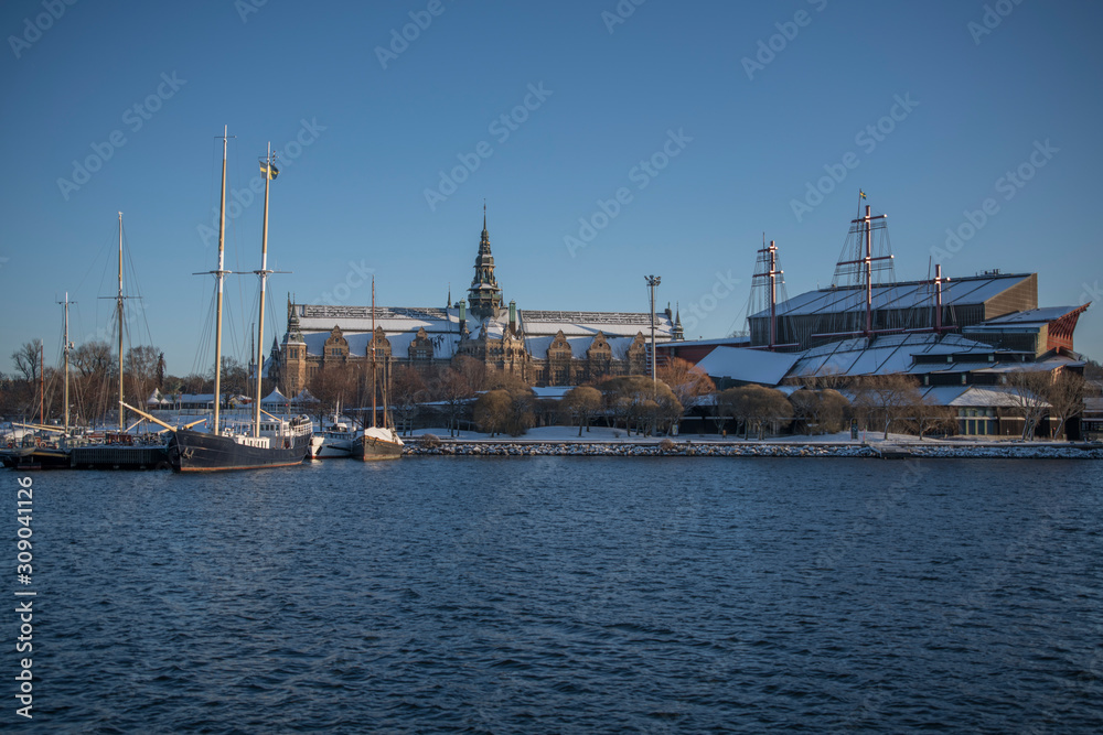 Panorama view over a snowy Stockholm inner harbour a sunny winterday with boats and landmarks