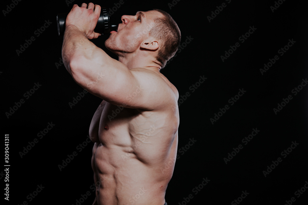 the athlete bodybuilder drinks water out of a Shaker