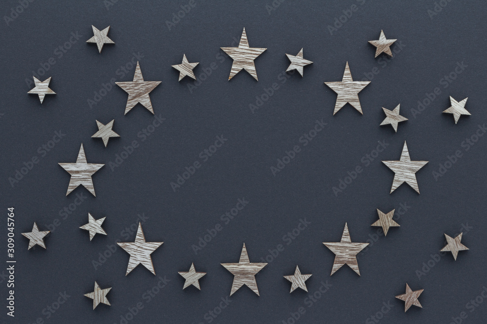 Christmas composition. Wood stars on blue background top view background with copy space for your text. Flat lay.