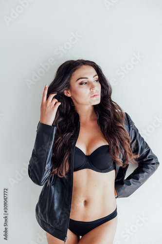 brunette girl in leather jacket and black lingerie