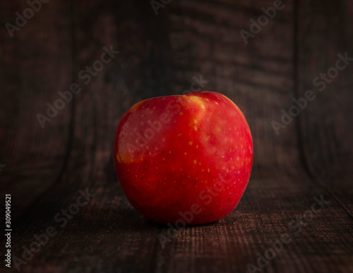 red apple on wooden table