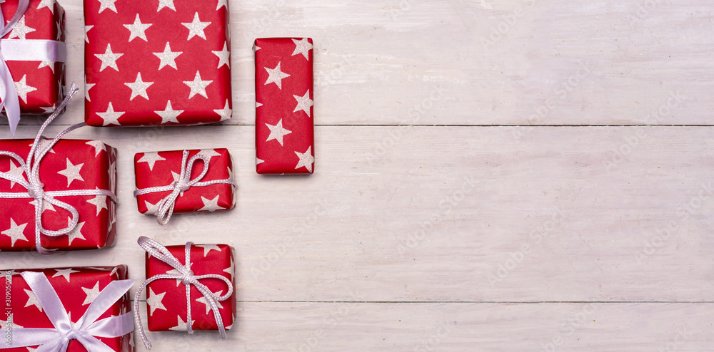 Fototapeta premium Christmas presents on a wooden table with copy space
