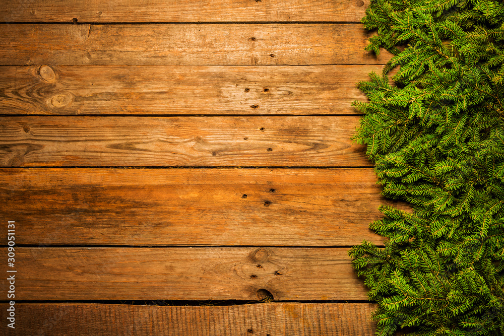 Wooden christmas background with green pine branches Wooden christmas background with green pine branches