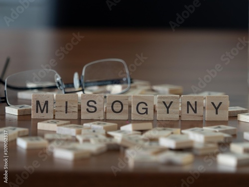 misogyny the word or concept represented by wooden letter tiles