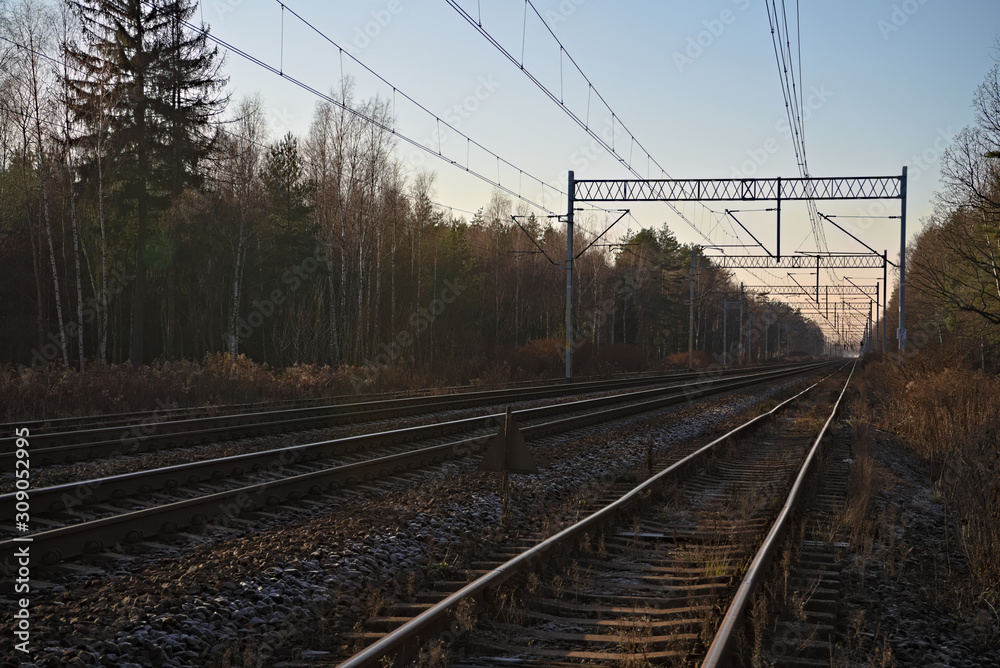 Empty train tracks at sunset