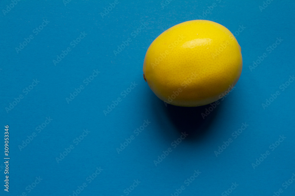 Top view fresh yellow lemon isolate on blue background, background or concept Top view fresh yellow lemon isolate on blue background, background or concept