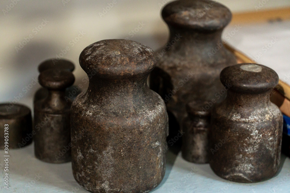 old metal weights for mechanical scales. Rusty metal from the past. Measuring instrument for a trading company. old metal weights for mechanical scales. Rusty metal from the past. Measuring instrument for a trading company.