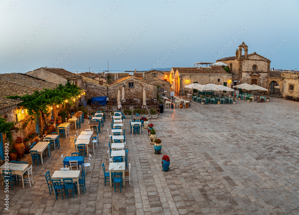 Aerial view of the small colorful village Marzamemi and typical italian cafe in Sicily