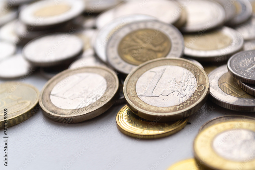 Several euro coins on light blurred background. Closeup photo Several euro coins on light blurred background. Closeup photo