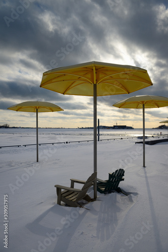 HTO Park beach umbrellas and Muskoka chairs with winter snow and Toronto Island Airport photo