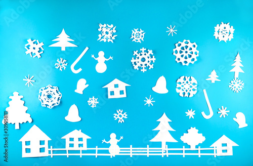 Fototapeta Naklejka Na Ścianę i Meble -  Christmas theme figures made of white paper on blue background