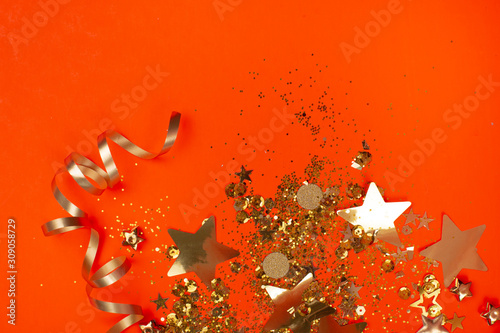 Golden sparkles on coral background. Holiday concept.