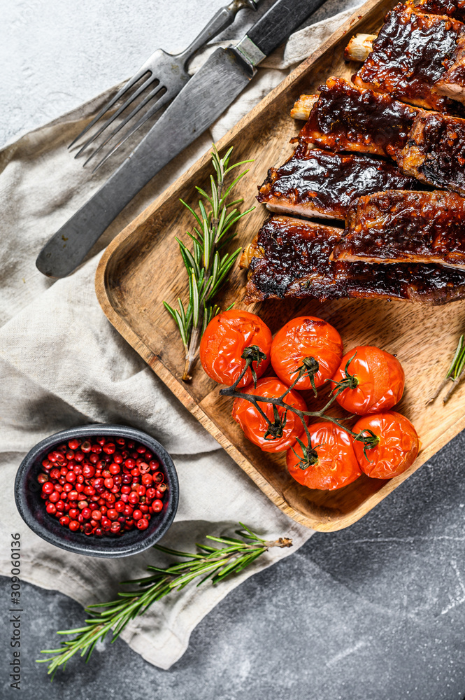 Roasted sliced barbecue pork ribs. Grilled meat. Gray background. Top view
