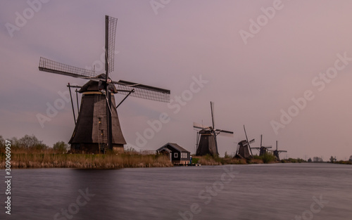 A row of 4 Dutch windmills at Kinderdijk (UNESCO World Heritage Site), the Netherlands.