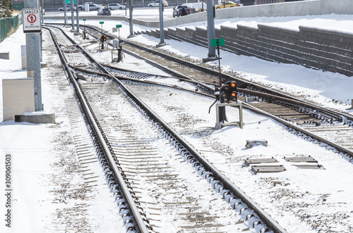 Switches on railway tracks covered in snow on a sunny winnter morning