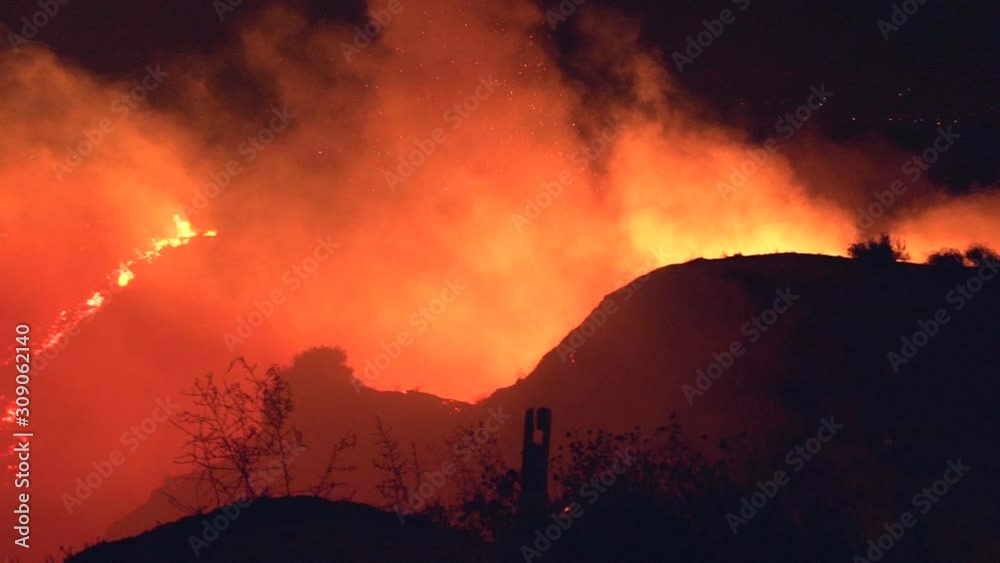 Slow motion, pan, shot, overlooking smoke and burning nature, at the Californian wildfires, night time, in Northridge, Los Angeles, California, USA Slow motion, pan, shot, overlooking smoke and burning nature, at the Californian wildfires, night time, in Northridge, Los Angeles, California, USA