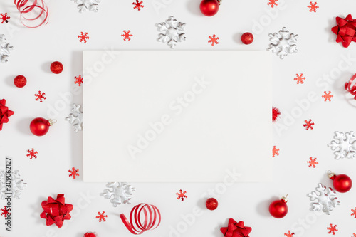 Christmas holiday composition. Paper blank, Xmas decorations on white background. Christmas, New Year, winter concept. Flat lay, top view, copy space photo