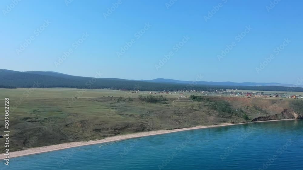 Lake Baikal, Russia. The drone flies to the coast over the water. Aerial video shot. View of the valley. Lake Baikal, Russia. The drone flies to the coast over the water. Aerial video shot. View of the valley.