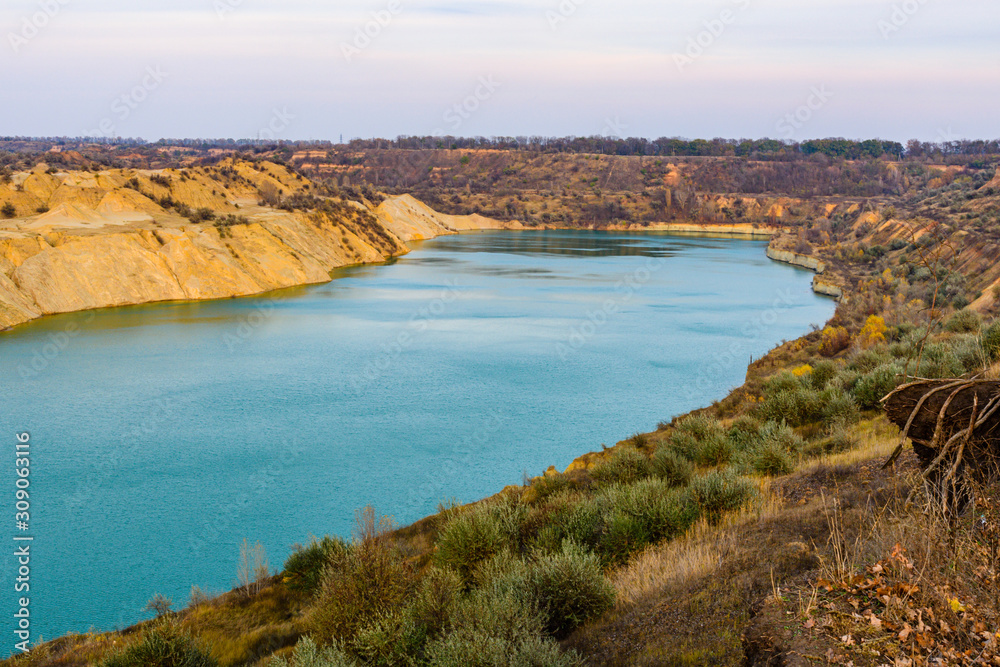 Fototapeta premium Lake with sandy bank in the abandoned coal quarry