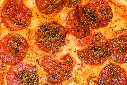 Background of the pizza with salami sausage and parmesan cheese