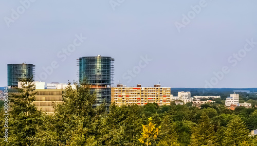 view on the city buildings from the forest of apeldoorn, popular dutch city, The netherlands