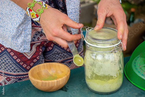 Hands Preparing Matcha Tea with Powder