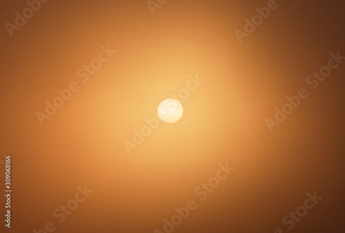 Giant orange sun ball during sunrise