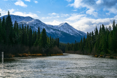 Natural scenery overlooking the Northern Rockies with evergreen landscape river somewhere on the Cassair Highway in Canada