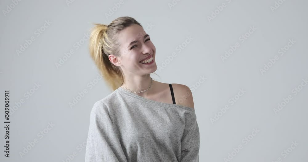 Happy young woman posing in off shoulder top over white background Happy young woman posing in off shoulder top over white background