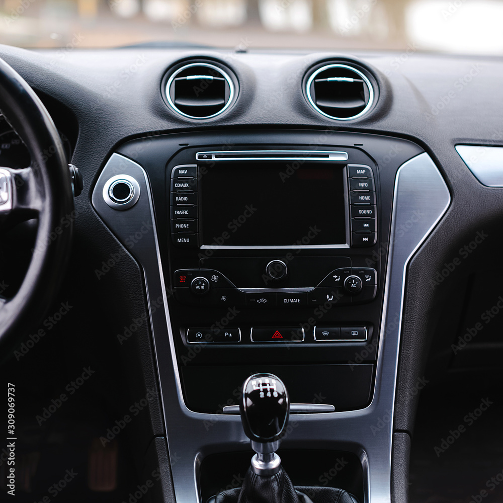 Modern car interior. Steering wheel, gearshift lever, multimedia system, driver's seat and dashboard.