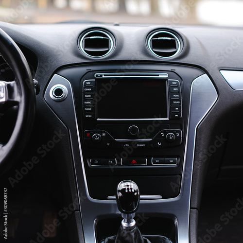Modern car interior. Steering wheel, gearshift lever, multimedia system, driver's seat and dashboard. © kucheruk