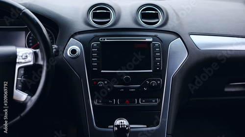 luxury car Interior - multimedia display, steering wheel, shift lever and dashboard. 