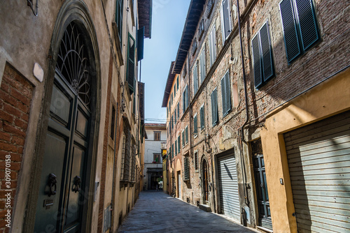 Narrow streets of Lucca ancient town with traditional architecture  Italy