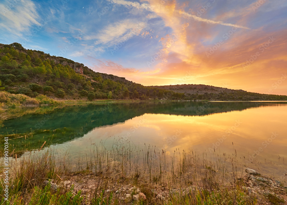 Landscape view of the sunset in the Laguna La Lengua Lake of the Lagunas de Ruidera Lakes Natural Park, Albacete province, Castilla la Mancha, Spain	