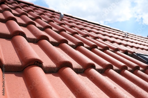 Red brown ceramic roof tiles and sky