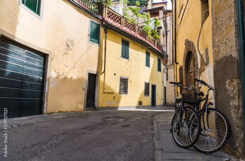Narrow streets of Lucca ancient town with traditional architecture, Italy