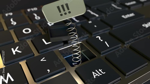Computer keyboard and jack-in-the-box triple exclamation mark in the key. Conceptual 3D animation photo