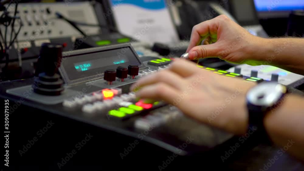 Live tv broadcast from video mixer console with mens hands