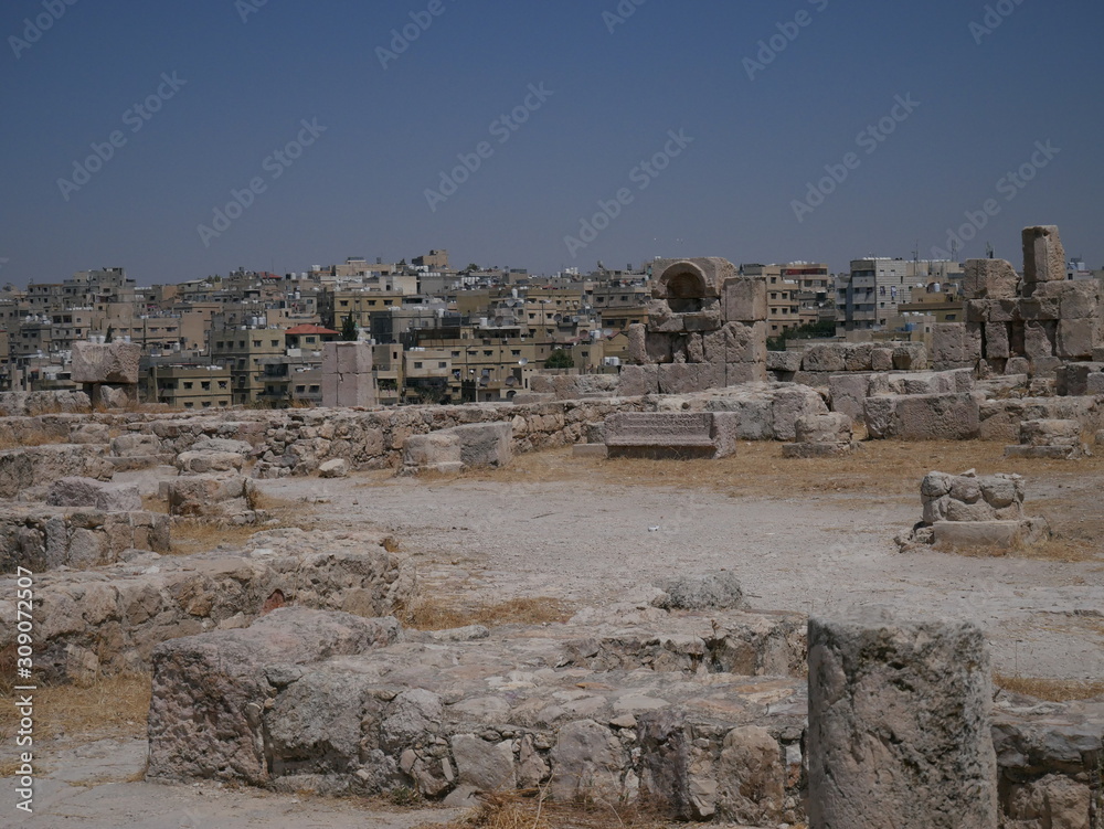 Roman ruins of the citadel of Amman, capitol of Jordan, remains of a city build from stone and tall pillars on a brown hill in the middle of a city Roman ruins of the citadel of Amman, capitol of Jordan, remains of a city build from stone and tall pillars on a brown hill in the middle of a city