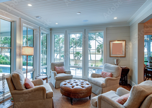 Beautiful sitting room interior with view out onto waterfront property.