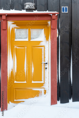 yellow door cover in snow and ice
