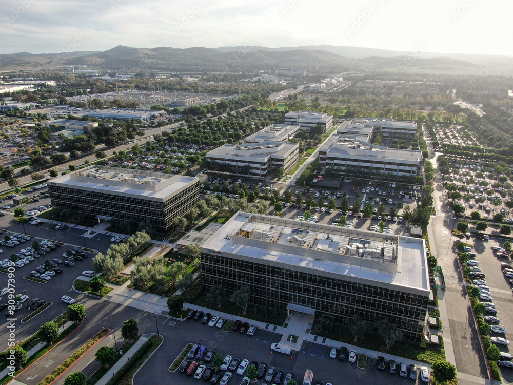 Aerial view of business and finance district with new office building surrounded by parking and road. Irvine Business Complex. Irvine California. USA - obrazy, fototapety, plakaty 