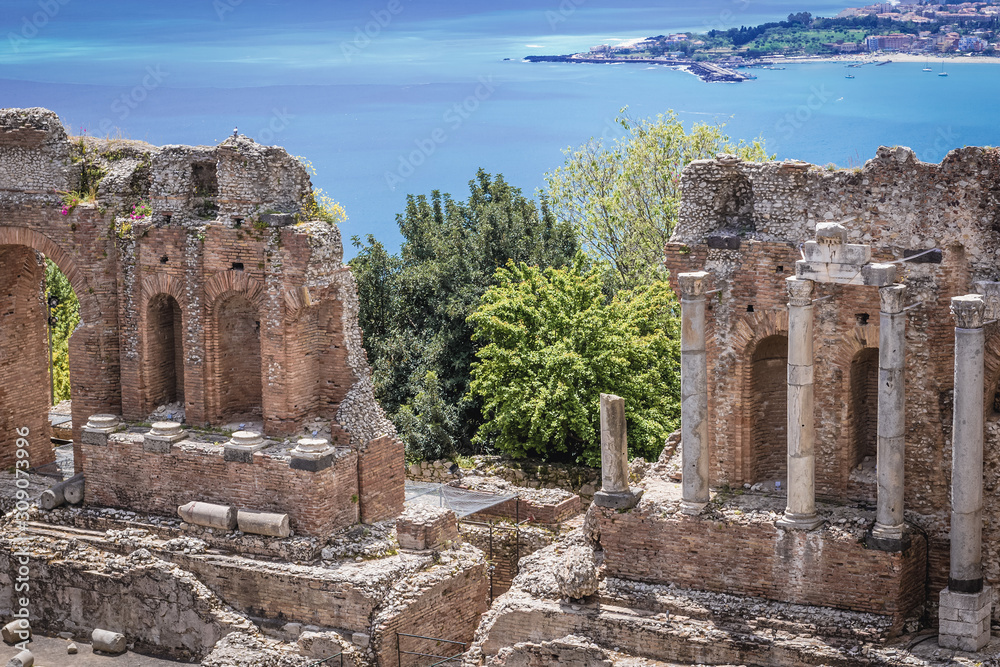 Ancient columns of Greek Theatre in historic part of Taormina city on Sicily Island, Italy